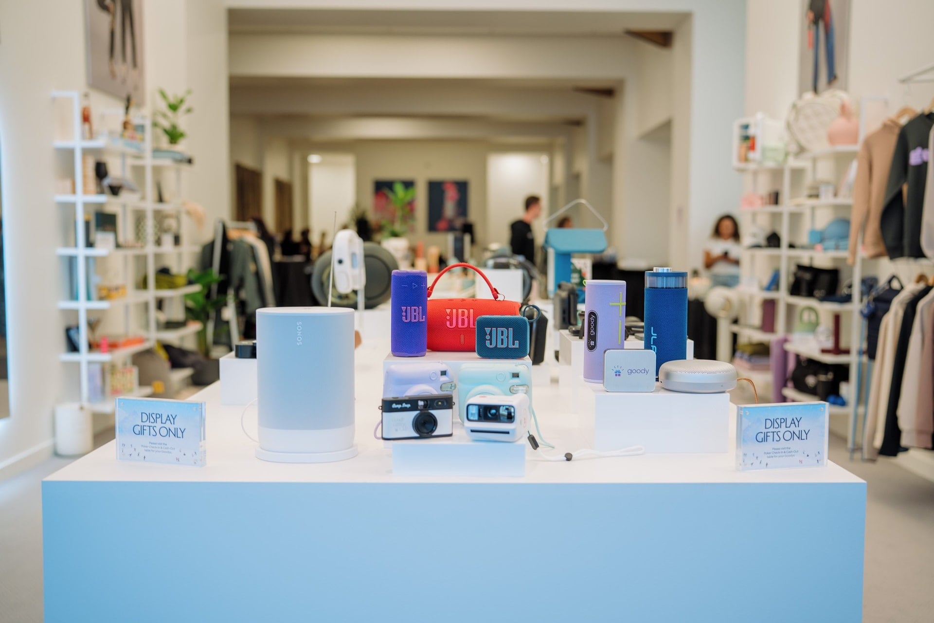 Colorful speakers, cameras, and tech gifts displayed in the Goody showroom